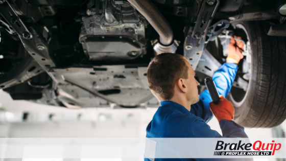 Man replacing brake hose on vehicle